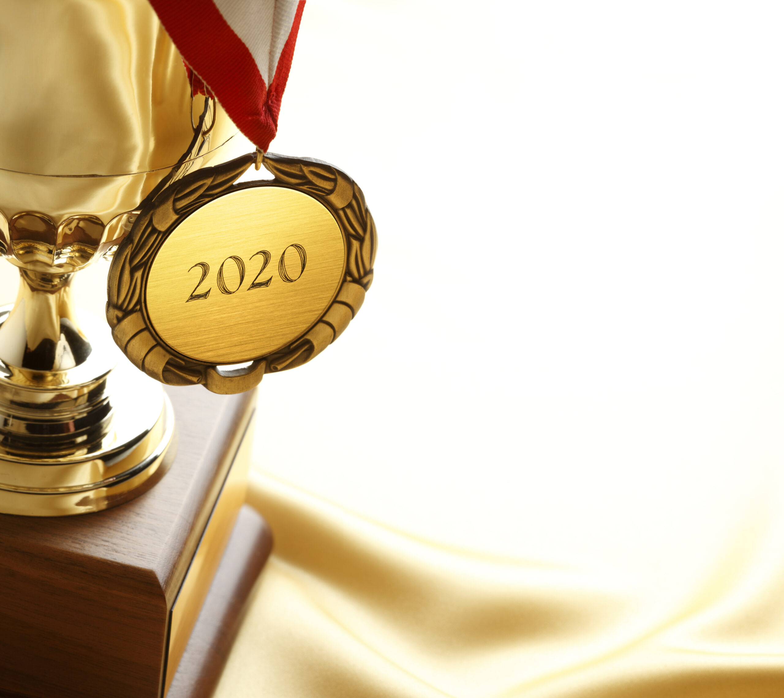 Gold Medal Engraved With 2020 Hangs From A Gold Trophy Gold Medal Engraved With 2020 Hangs From A Gold Trophy